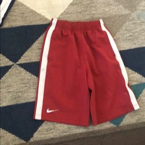Red Nike shorts with white line